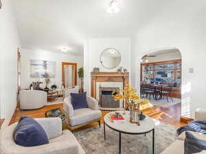 Living room featuring a brick fireplace and light hardwood / wood-style floors