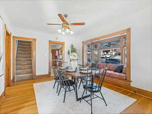 Dining room featuring wood-type flooring and ceiling fan