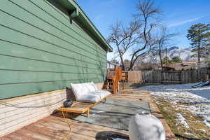 Snow covered deck featuring a mountain view