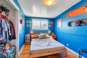 Bedroom featuring hardwood / wood-style floors and a closet