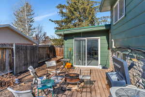 Deck featuring central AC unit and an outdoor fire pit