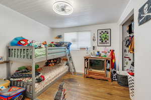 Bedroom featuring hardwood / wood-style flooring and ornamental molding