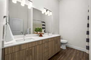 Primary bathroom with double vanity and walk in shower.