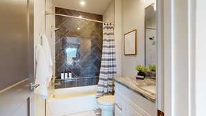 Full bathroom with toilet, vanity, and shower / bathtub combination with curtain