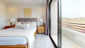 Bedroom with a mountain view and light wood-type flooring