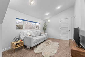 Upstairs living room featuring vaulted ceiling