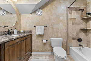 Upstairs Full bathroom with vanity, toilet, tiled shower / bath combo