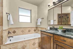 Primary bathroom featuring independent shower and bath and vanity