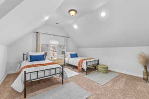 Upstairs bedroom featuring vaulted ceiling and walk in closet