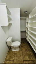 Bathroom with tile patterned flooring and toilet