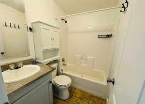 Full bathroom with vanity, tile patterned floors, bathtub / shower combination, and toilet