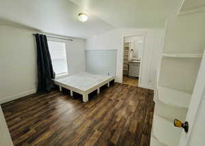 Dining area featuring vaulted ceiling and dark hardwood / wood-style floors