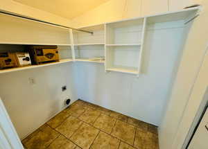 Clothes washing area with tile patterned flooring and hookup for an electric dryer