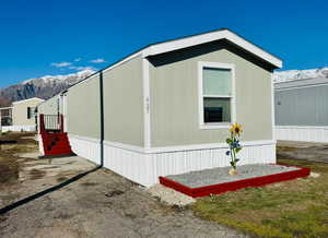 View of side of home featuring a mountain view