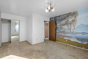 Unfurnished bedroom with carpet floors and a water view