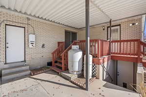 View of exterior entry with a patio