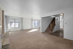 Unfurnished living room featuring carpet flooring