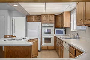 Kitchen featuring sink and white appliances