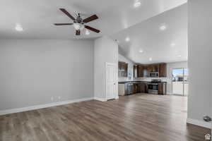 Unfurnished living room with ceiling fan, lofted ceiling, and light hardwood / wood-style flooring