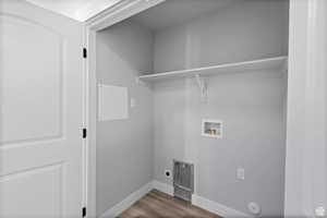 Laundry room featuring washer hookup, hookup for an electric dryer, hookup for a gas dryer, and hardwood / wood-style floors
