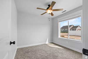 Spare room with carpet floors and ceiling fan