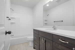 Full bathroom featuring vanity, bathing tub / shower combination, and toilet
