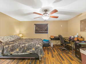 Bedroom featuring ceiling fan and dark hardwood / wood-style flooring