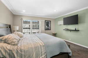 Carpeted bedroom featuring ornamental molding