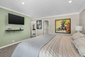 Bedroom featuring crown molding and carpet floors