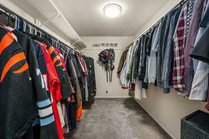 Spacious closet featuring carpet flooring