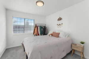 Newly Carpeted bedroom with a textured ceiling