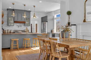 Dining room featuring sink and light hardwood / wood-style floors