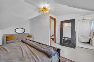 Bedroom with lofted ceiling, a chandelier, and light wood-type flooring