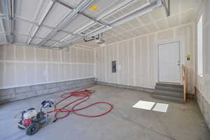 Garage with a garage door opener and electric panel