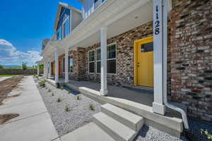 View of exterior entry featuring a porch