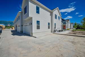 Rear view of house featuring a garage and a mountain view