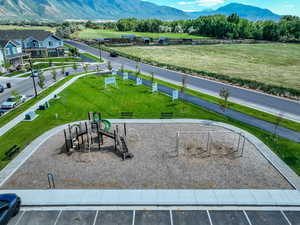 View of property's community with a playground and a mountain view