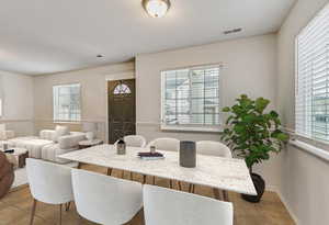 Dining space featuring light tile patterned floors