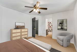 Carpeted bedroom featuring ceiling fan