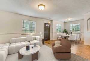 Tiled living room with a textured ceiling