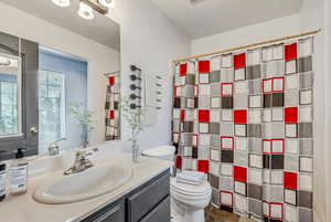 Bathroom featuring vanity, toilet, full bath.