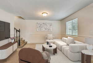 Living room with light carpet and a textured ceiling