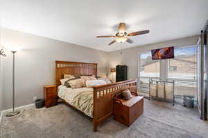 Carpeted bedroom with ceiling fan