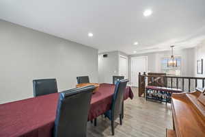 Dining area featuring a chandelier and light hardwood / wood-style flooring