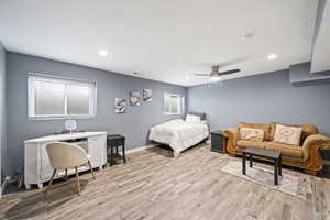 Bedroom with light hardwood / wood-style flooring and ceiling fan