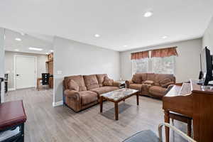 Living room featuring light wood-style floors and recessed lighting