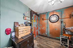 Misc room with dark wood-type flooring