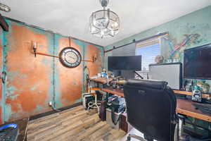 Office featuring a chandelier and hardwood / wood-style floors