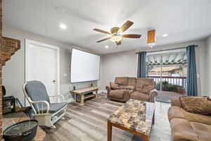 Interior space featuring a textured ceiling, ceiling fan, and light hardwood / wood-style flooring