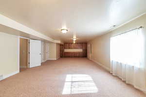 Unfurnished bedroom with light colored carpet